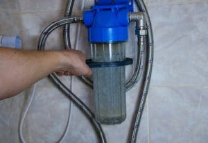 Plumber installs water softener