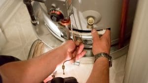 Plumber servicing a water heater 