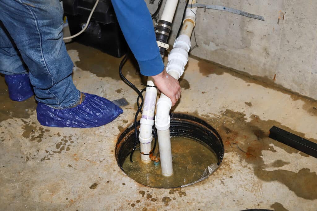 plumber repairing a sump pump